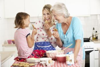 Mother,Daughter And Grandmother Baking In Kitchen