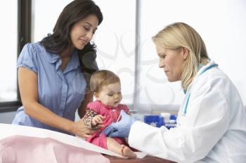 Doctor In Surgery Giving Baby Girl Injection