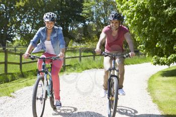 Young Couple On Cycle Ride In Countryside