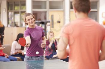 College Students Relaxing And Playing Table Tennis