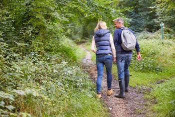 Mature Couple On Walk Through Beautiful Countryside