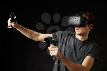 Man In Studio Wearing Virtual Reality Headset Playing Game