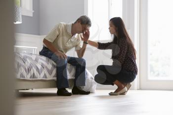 Adult Daughter Talking To Depressed Father At Home
