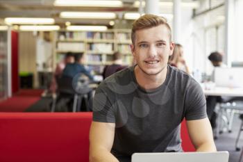 Portrait Of Male University Student Working In Library