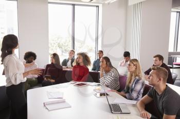 Group Of University Students Attending Lecture On Campus
