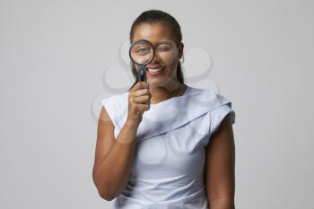 Portrait Of Female Criminologist With Magnifying Glass
