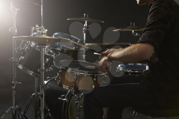 Close Up Of Drummer Playing Drum Kit In Studio