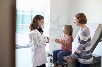 Pediatrician Meeting With Mother And Child In Exam Room
