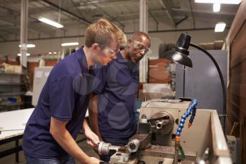 Engineer Training Male Apprentice On Milling Machine