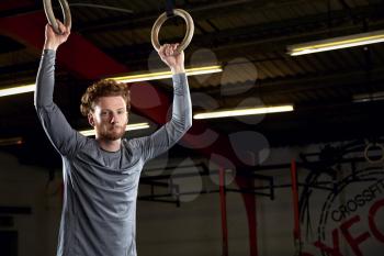 Portrait Of Young Man In Gym With Olympic Rings