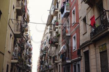 BARCELONA - JULY 29, 2016: View down a densely populated narrow residential street