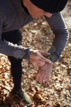 Mature Man On Autumn Run Checking Activity Tracker