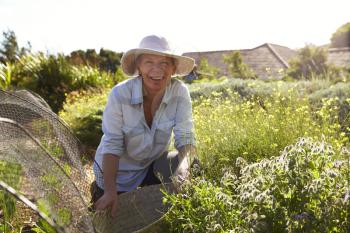 Portrait Of Mature Woman Working On Community Allotment