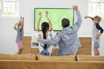 Family Watching Sports On Television And Cheering