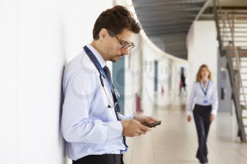 Portrait of young male doctor with stethoscope and smartphone