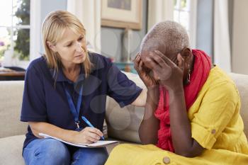 Support Worker Visits Senior Woman Suffering With Depression
