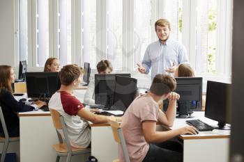 Teenage Students Studying In IT Class With Teacher
