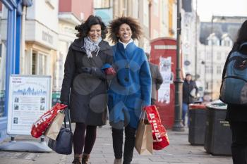 Two Mature Female Friends Enjoying Shopping In City Together