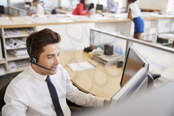 Hispanic male call centre worker at work, elevated view