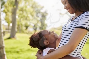 Close Up Of Mother Hugging Daughter In Park