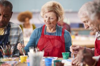 Retired Senior Woman Attending Art Class In Community Centre