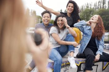 Group Of Female Friends Posing For Selfie On Mobile Phone In Urban Skate Park