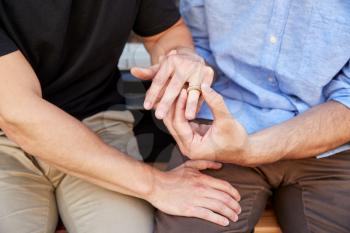 Close Up Of Man Proposing To Male Partner With Ring