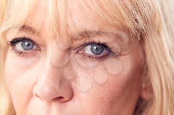 Studio Close Up Of Mature Woman Looking Suspicious And Distrustful
