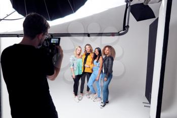 Group Studio Photo Shoot Of Young Multi-Cultural Female Friends Smiling And Laughing At Camera