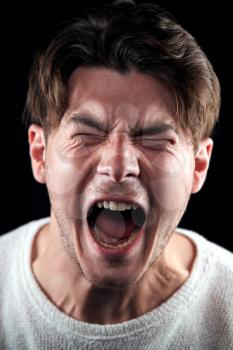 Head And Shoulders Studio Shot Of Angry Man Shouting At Camera