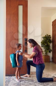 Mother Saying Goodbye To Daughter As She Leaves Home For School