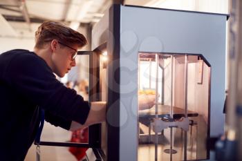 Male College Student Studying Engineering Using 3D Printing Machine