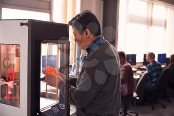 Mature Male College Student Studying Engineering Using 3D Printing Machine