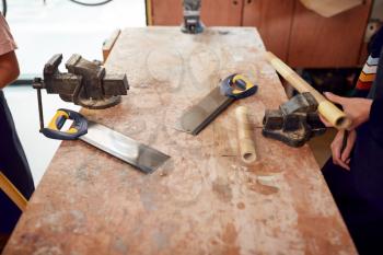 Close Up Of Tools On Workbench In Workshop Assembling Hand Built Sustainable Bamboo Bicycle Frames