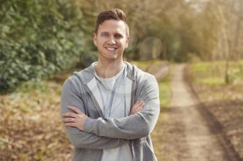 Portrait Of Smiling Man Running In Autumn Countryside Exercising During Covid 19 Lockdown