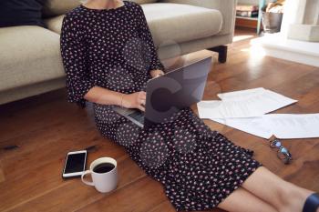 Close Up Of Businesswoman Sitting On Floor With Laptop Working From Home In Pandemic Lockdown