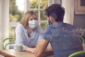Couple Wearing Masks Meeting In Coffee Shop During Health Pandemic Through Window