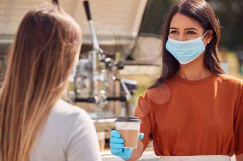Woman Wearing Face Mask Running Mobile Coffee Shop Serving Female Customer Next To Van