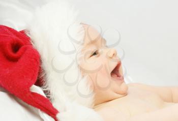 Baby boy laughing in santas hat