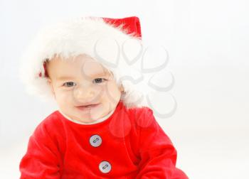 Smiling baby boy in santa outfit