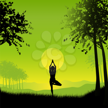 Silhouette of a female in a yoga pose under a sunset sky