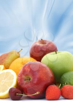 Display of fresh fruit on abstract blue background
