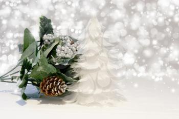 Christmas tree of feathers and greenery on silver starry background