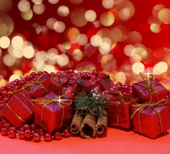 Royalty Free Photo of Christmas Boxes and Cinnamon Sticks Against Blurred Lights