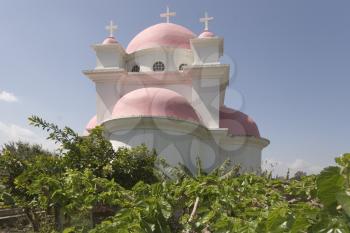 Orthodox church on coast of the lake of Tiberias, shined by the sun, a church garden and a vineyard
