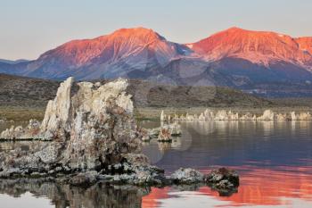 Sunrise on lake Mono in a crater of an ancient extinct volcano. Lake shallow, in it set of picturesque reeves of the Tufa