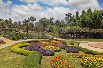 The most beautiful park in Southeast Asia. A masterpiece of landscape gardening - huge park in Thailand. Magnificent flower beds, green lawns and tropical trees