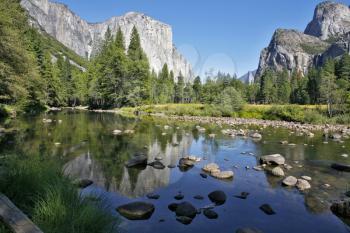 Well-known rocky monolith Эл - Captain are reflected in the river Mersed in Yosemite park