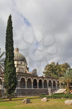 The majestic dome and gallery with columns are surrounded by cypresses. Basilica on Mount of Beatitudes. 