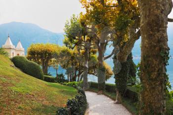 Magnificent park at the Italian villa-museum Balbyanello. Lake Como in the misty haze
